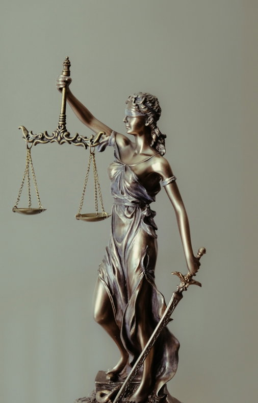 woman-in-gold-dress-holding-sword-figurine.jpg woman in gold dress holding sword figurine